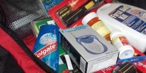 An emergency preparedness kit with toothpaste, batteries, medications, and other items