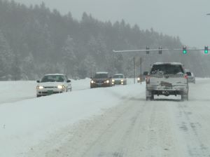 Snow covered road with vehicles travelling 