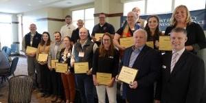 14 Vermont Certified Emergency Management Directors showing their certificates for the photo